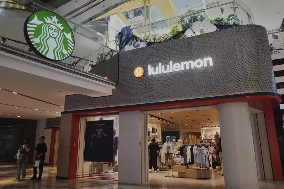 Shoppers tour a Starbucks cafe and a Lululemon store inside a shopping mall, in Beijing, Thursday, April 10, 2025. (AP Photo/Andy Wong)