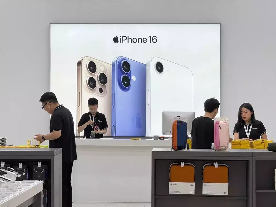 Sales staff members work at an Apple shop in Hanoi, Vietnam Thursday, April 10, 2025. (AP Photo/Hau Dinh)