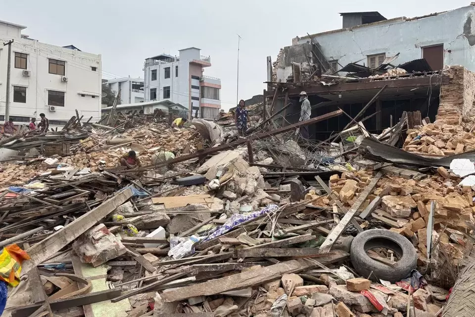 People clean debris from damaged buildings in the aftermath of an earthquake on March 28, in Naypyitaw, Myanmar, Monday, April 7, 2025. (AP Photo)