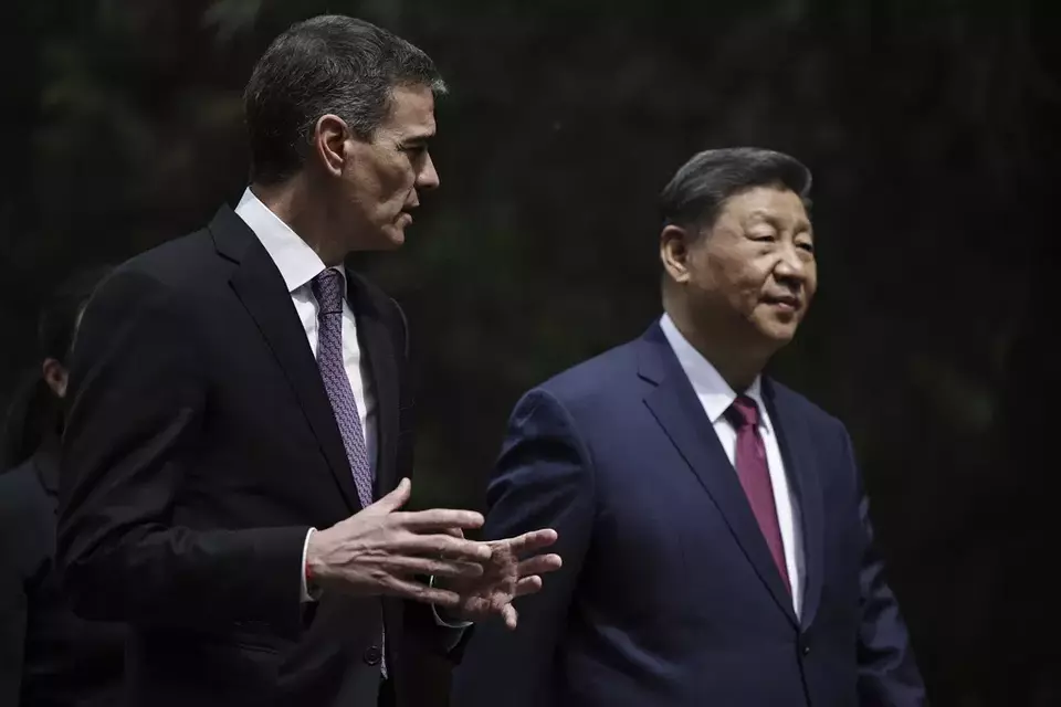 Chinese President Xi Jinping, right, and Spanish Prime Minister Pedro Sanchez speak as they walk along the gardens of Diaoyutai Guest House after a meeting in Beijing, China, Friday, April 11, 2025. (Andres Martinez Casares/Pool Photo via AP)