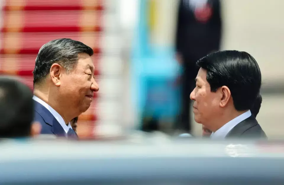 Chinese President Xi Jinping, left, meets with Vietnam's President Luong Cuong on his arrival at the Noi Bai International Airport in Hanoi, Vietnam Monday, April 14, 2025. (Athit Perawongmetha/Pool Photo via AP)
