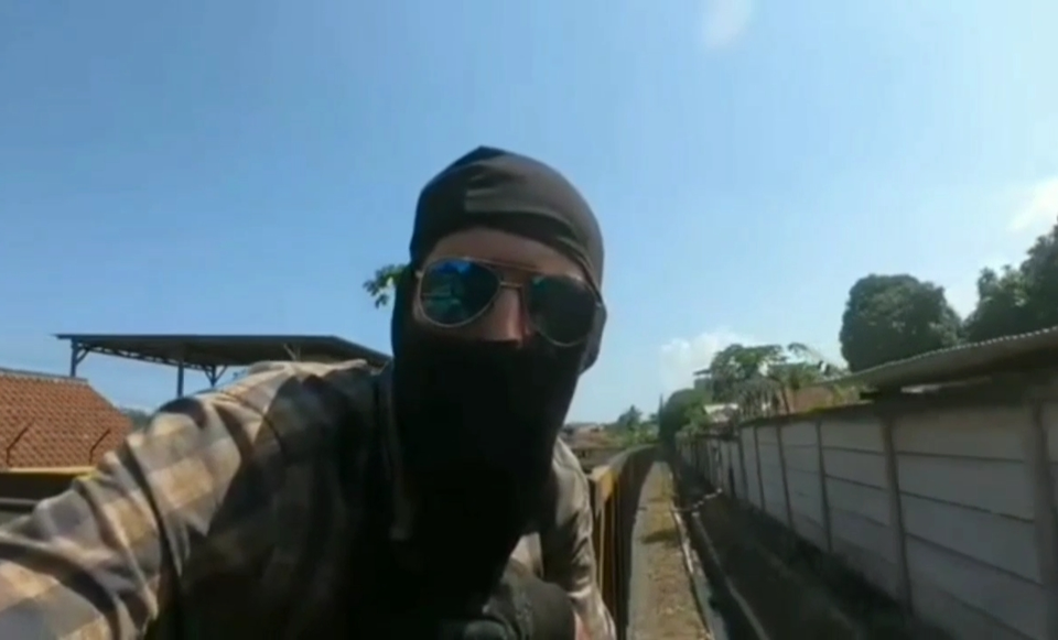 A capture from a video shows a Russian national ride the Babaranjang freight train from Lampung to Sumatra.