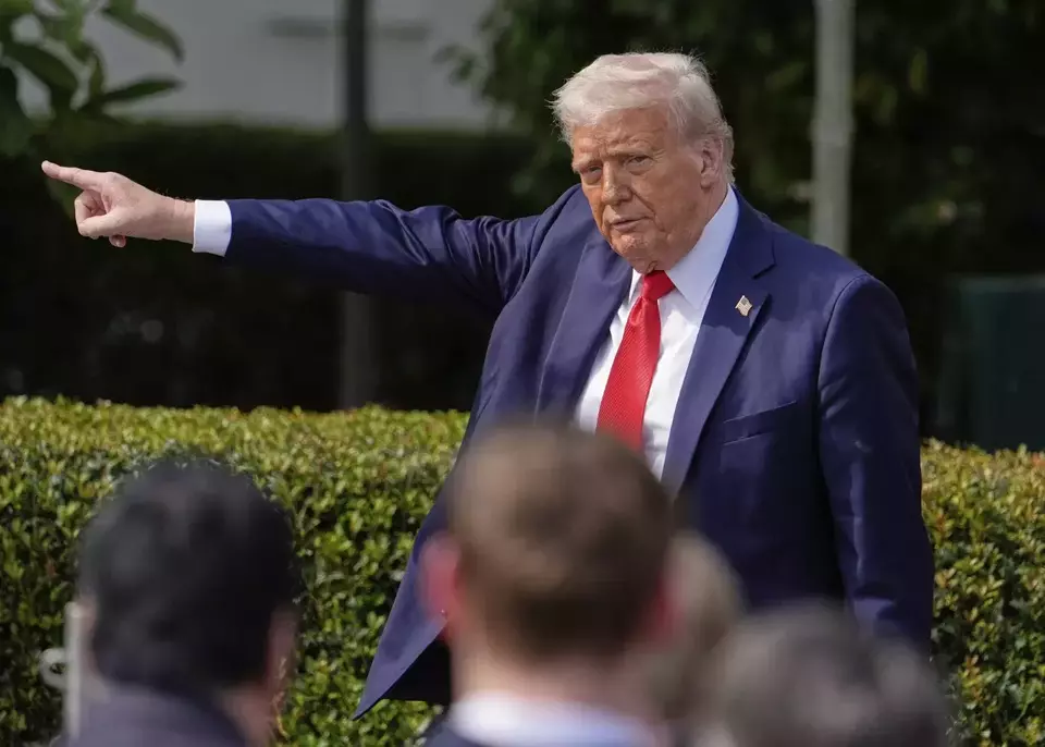 US President Donald Trump gestures to the crowd as he departs after welcoming the 2025 College Football National Chamions, the Ohio State University football team, during an event on the South Lawn of the White House on April 14, 2025, in Washington. (AP Photo/Manuel Balce Ceneta)