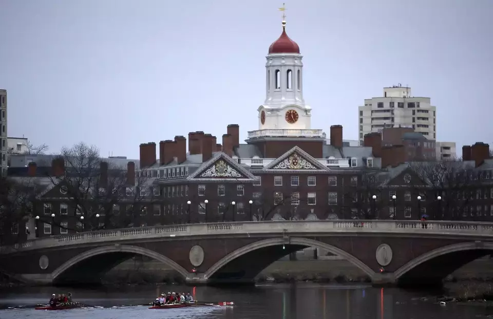 FILE - Rowers paddle down the Charles River near the campus of Harvard University in Cambridge, Mass., March 7, 2017. (AP Photo/Charles Krupa, File)
