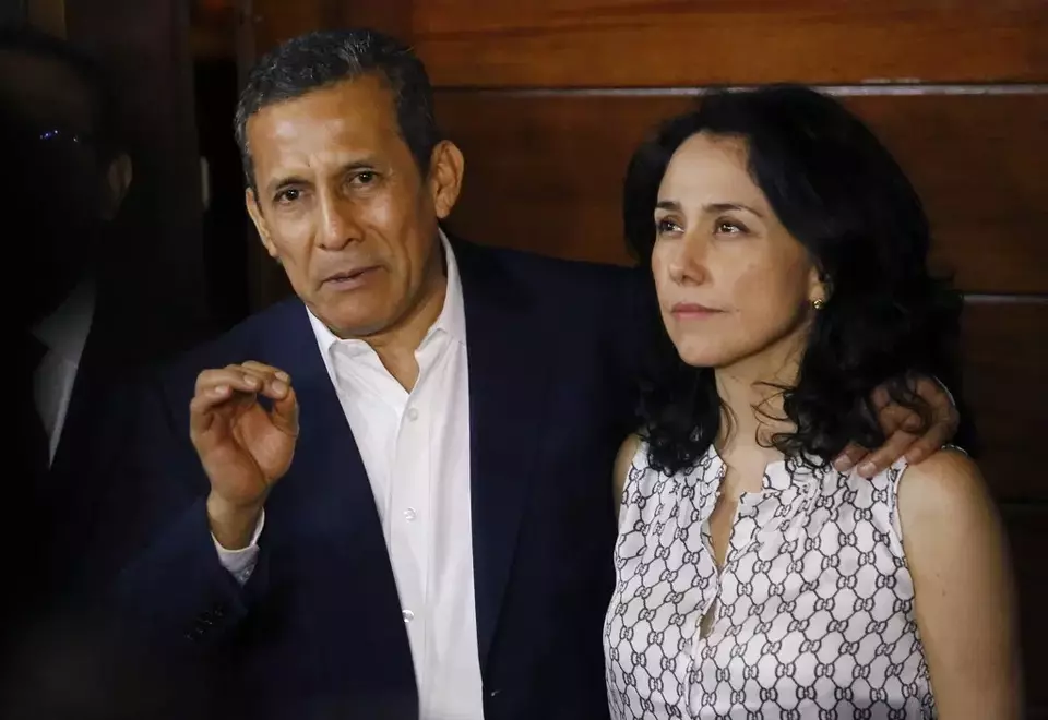 FILE - Peru's former President Ollanta Humala, accompanied by his wife Nadine Heredia, speaks to reporters at the entrance of their home after they were released from prison in Lima, Peru, April 30, 2018. (AP Photo/Joel Alonzo, File)