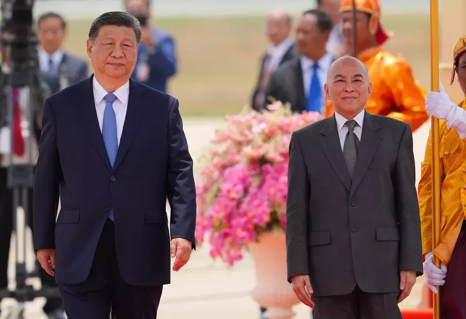 In this photo released by Agence Kampuchea Press (AKP), Cambodia's King Norodom Sihamoni, right, and Chinese President Xi Jingping attend a welcome ceremony at Phnom Penh International Airport in Phnom Penh, Cambodia, Thursday, April 17, 2025. (AKP via AP)