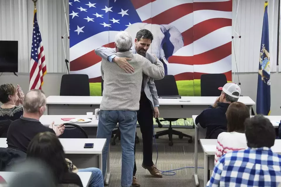 Ryan Kelley, right, hugs William Hank Choate during his talk at the Jackson County Republican headquarters Thursday, April 10, 2025, in Jackson, Mich. (AP Photo/Paul Sancya)