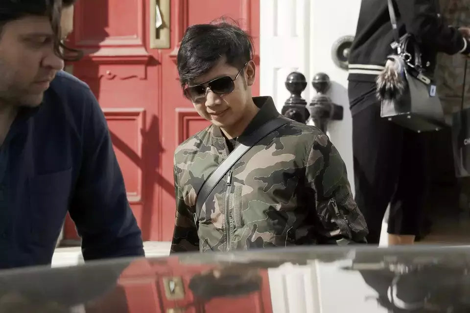 Vorayuth "Boss" Yoovidhya, whose grandfather co-founded energy drink company Red Bull, walks to get in a car as he leaves a house in London, on April 5, 2017. (AP Photo/Matt Dunham, File)