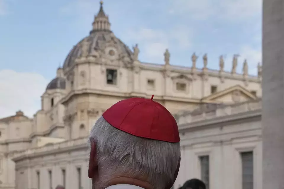 St Peter's Basilica is seen in the background as a cardinal arrives for a college of cardinals' meeting, at the Vatican, Monday, April 28, 2025. (AP Photo/Gregorio Borgia)