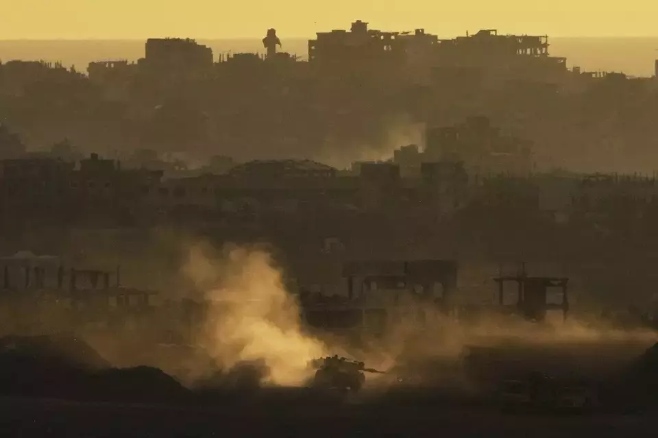 An Israeli army tank maneuvers in the Gaza Strip is seen from southern Israel, Sunday, May 4, 2025. (AP Photo/Ariel Schalit)
