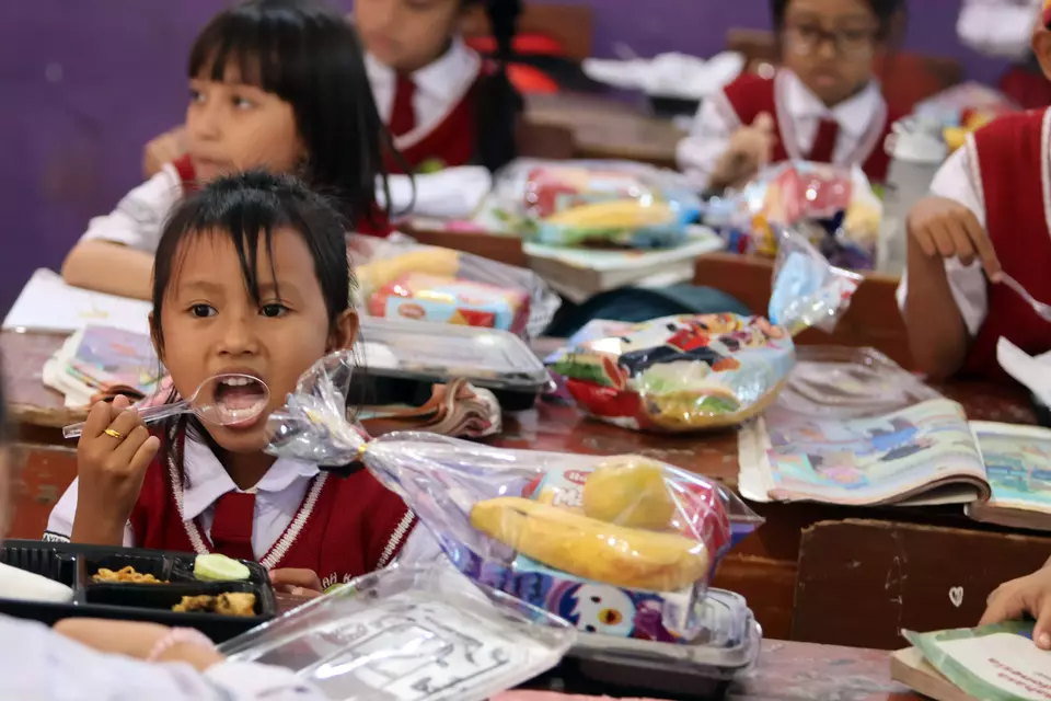 Children enjoy the government-aided free meal packages at an elementary school in Bogor, West Java, on May 5, 2025. (Antara Photo/Yulius Satria Wijaya)