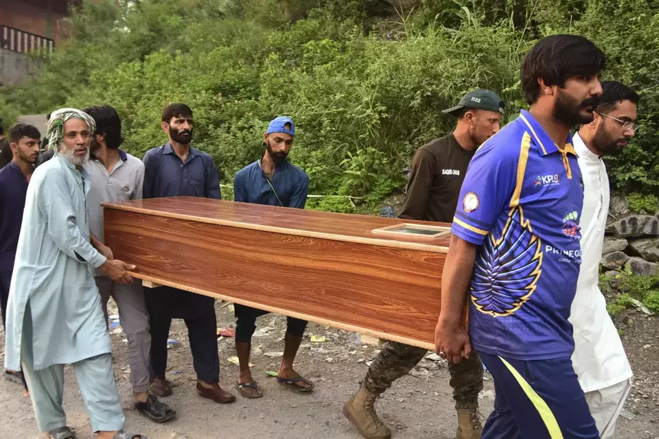 Volunteers carry a body after recovering it from the rubble of a mosque building damaged by a suspected Indian missile attack near Muzaffarabad, the capital of Pakistan controlled Kashmir, on May 7, 2025. (AP Photo/MD Mughal)