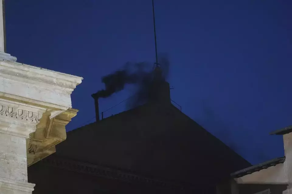 Black smoke billows from the chimney of the Sistine Chapel during the cardinals' conclave to elect a new pope, at the Vatican, Wednesday, May 7, 2025. (AP Photo/Alessandra Tarantino)
