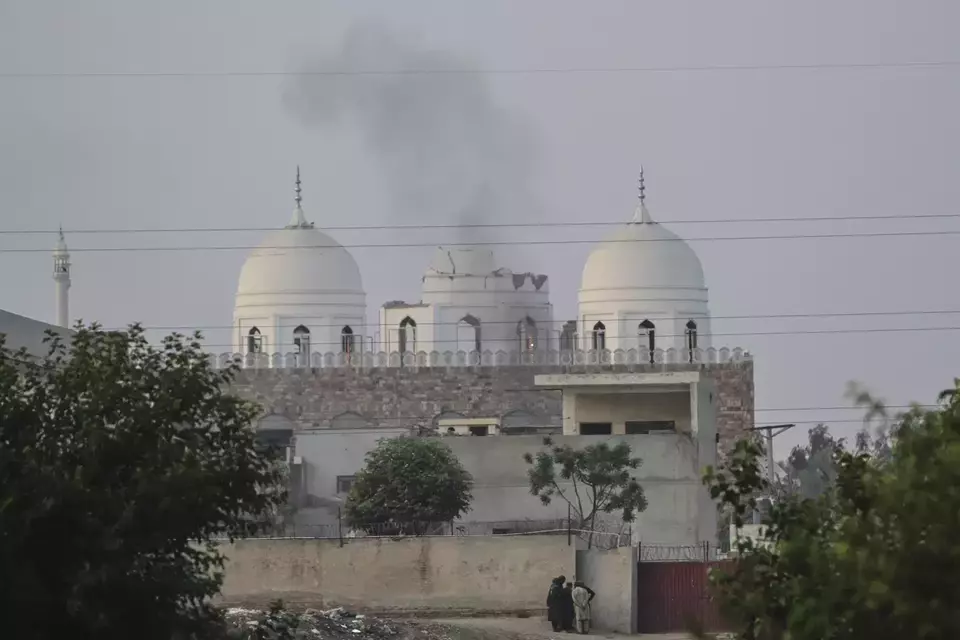 Local residents stand outside a mosque of an Islamic seminary partially damaged by a suspected Indian missile attack, outskirts of Bahawalpur, Pakistan on May 7, 2025. (AP Photo/Asim Tanveer)