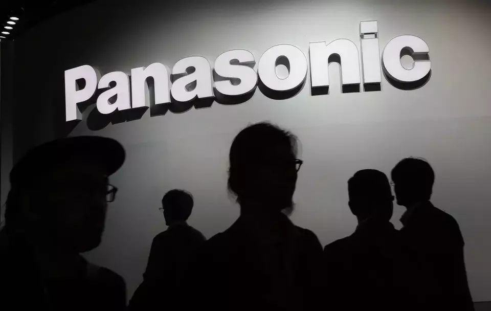 People walk by the Panasonic booth during CES International in Las Vegas on Jan. 9, 2018. (AP Photo/John Locher)