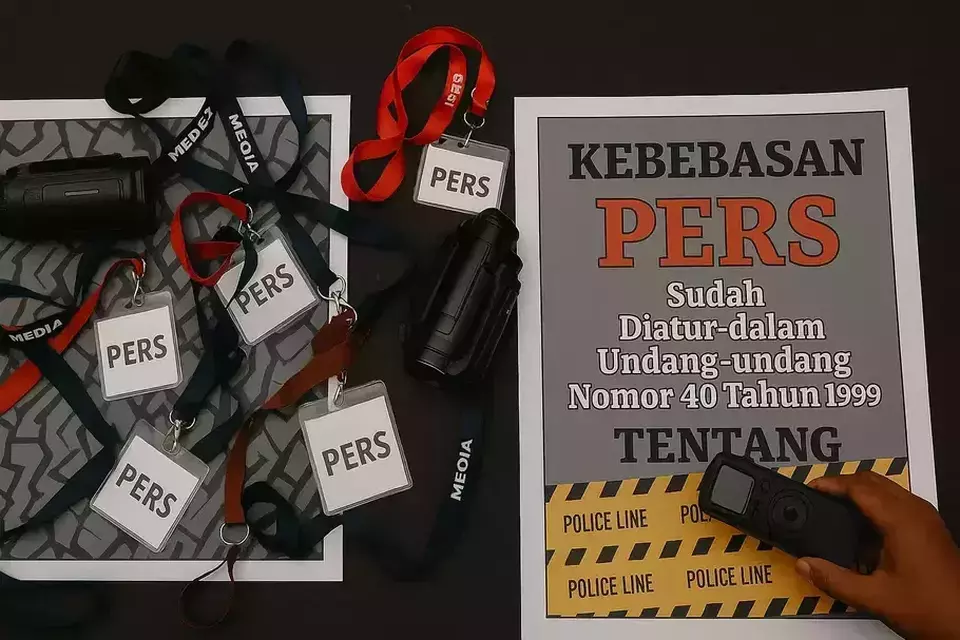 This file photo shows press cards and a banner that calls for press freedom. (B1 File Photo)