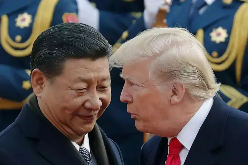 US President Donald Trump chats with Chinese President Xi Jinping during a welcome ceremony at the Great Hall of the People in Beijing on Nov. 9, 2017. (AP Photo/Andy Wong, File)
