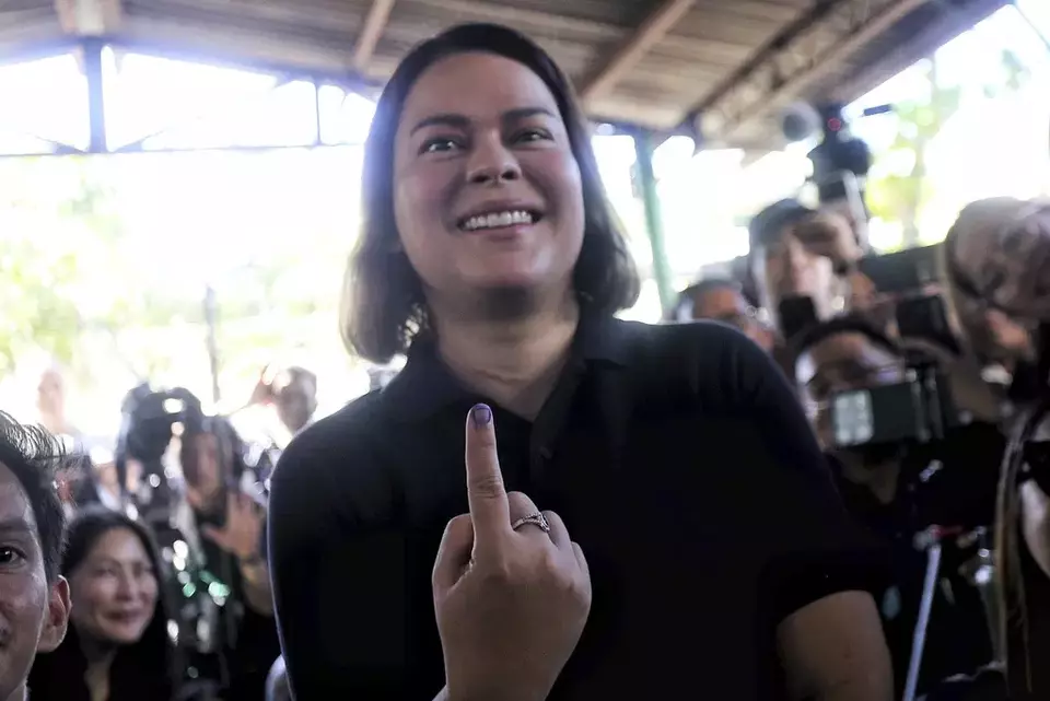 Philippine Vice President Sara Duterte shows the indelible ink on her finger after casting her vote at a polling center in Davao City, southern Philippines, Monday, May 12, 2025. (AP Photo/Manman Dejeto)