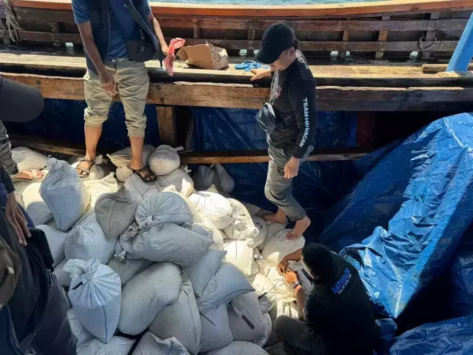 Officers of the Bangka Belitung Police inspect sacks of tin sand inside a vessel intercepted for a smuggling attempt during an operation on Thursday, May 15, 2025. (B-Universe Photo/Irwan Setiawan)