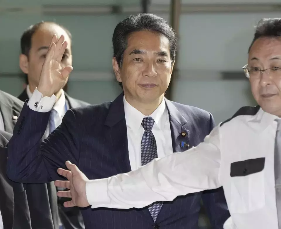 Japan's Agriculture Minister Taku Eto, center, arrives at the prime minister's office in Tokyo Wednesday, May 21, 2025. (Kyodo News via AP)

