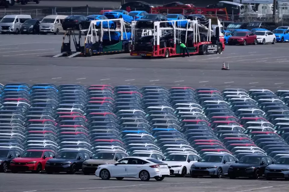 FILE - Workers unload vehicles at the Daikoku vehicle terminal center in Yokohama, near Tokyo, April 8, 2025. (AP Photo/Hiro Komae, File)