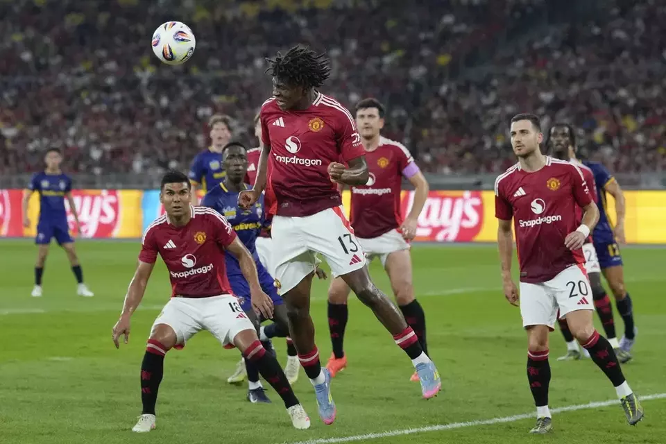 Manchester United's Patrick Dorgu, heads a ball during match withfights for the ball with ASEAN All-Star at the Challenge Cup Malaysia 2025 soccer tournament in Kuala Lumpur, Malaysia, Wednesday, May 28, 2025. (AP Photo/Vincent Thian)

