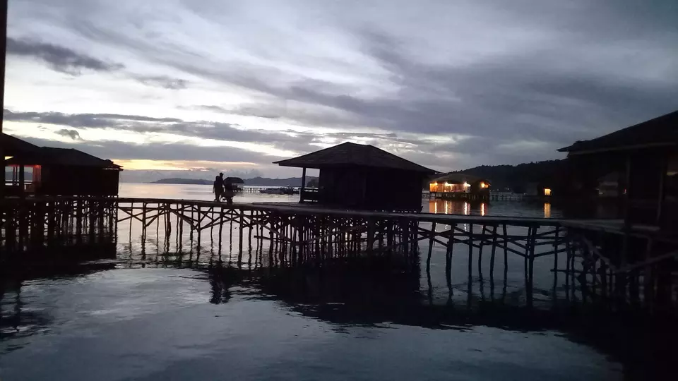 Tourists walk along a wooden bridge at a coastal resort in Raja Ampat Regency, Southwest Papua, Nov. 26, 2021. (JG Photo/Heru Andriyanto)