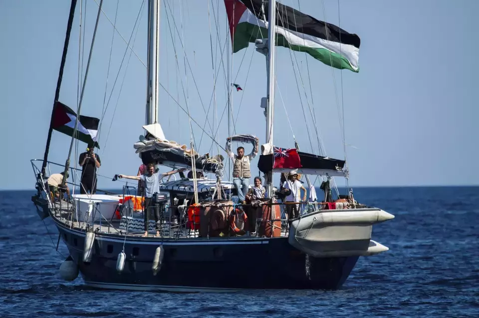 Activists of the Freedom Flotilla Coalition, board the Madleen boat, ahead of setting sail for Gaza, departing from the Sicilian port of Catania, Italy, on June 1, 2025. (AP Photo/Salvatore Cavalli)