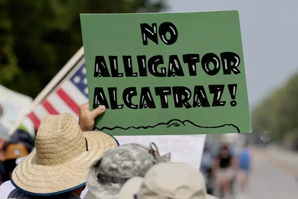 Environmental advocates and protesters at the Dade-Collier Training and Transition Airport on Tamiami Trail E, Ochopee, Florida, on Saturday, June 28, 2025, object to the 'Alligator Alcatraz' being built at the facility. (Mike Stocker /South Florida Sun-Sentinel via AP)