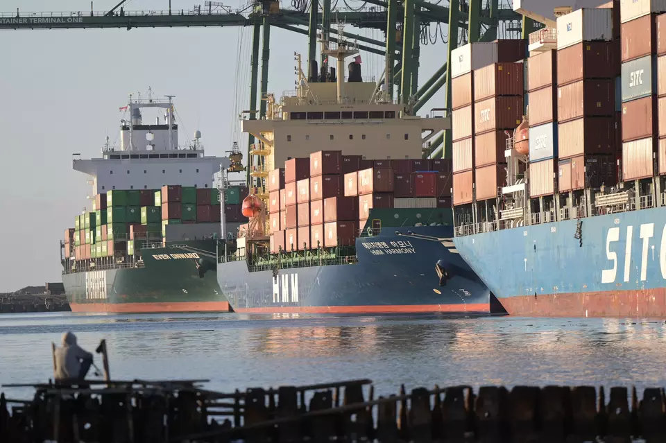 A man fishes across unloading activities at the New Priok Container Terminal One in Jakarta on July 1, 2025. (Antara Photo/Fauzan)