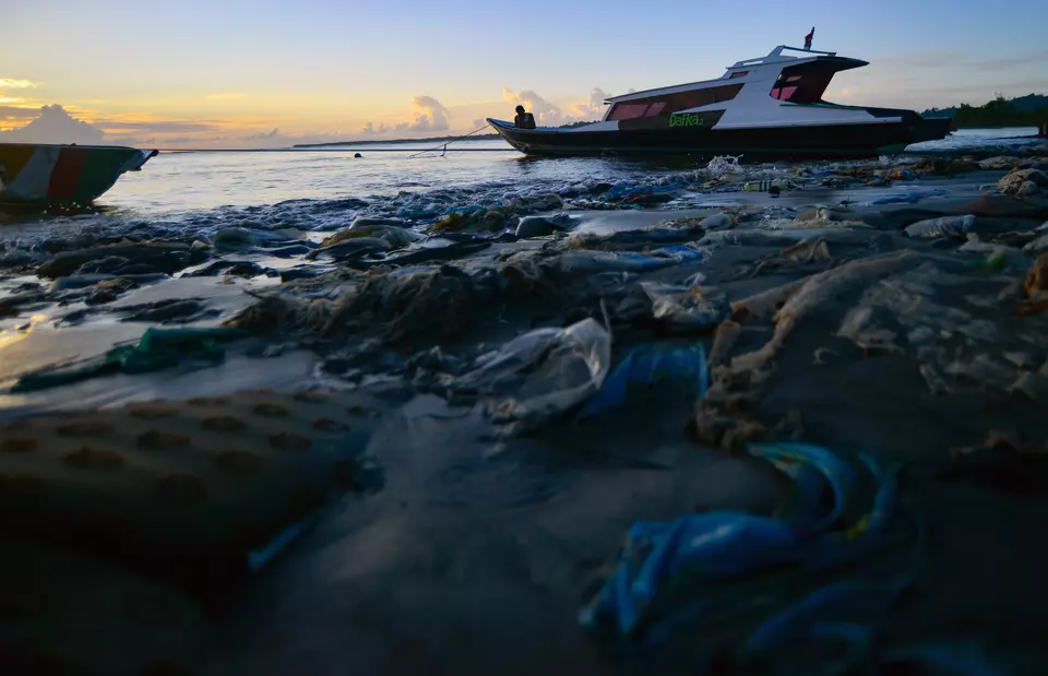 A man is fishing from a boat in Muara Siberut coast littered with plastic waste in Mentawai, West Sumatra, Tuesday, July 8, 2025. (Antara Photo/Iggoy el Fitra)