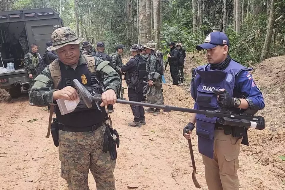 In this photo released by the Royal Thai Army, Thai soldiers inspect a border area on Sunday, July 20, 2025, in Ubon Ratchathani province, where the Royal Thai Army said two anti-personnel landmines were found. (Royal Thai Army via AP)
