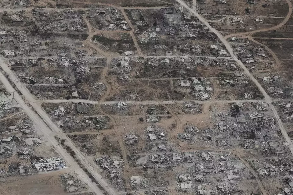 Destroyed buildings in the Gaza Strip are seen from a Jordanian Air Force C-130 plane during an airdrop of humanitarian aid for Palestinians, Thursday, Aug. 7, 2025. (AP Photo/Raad Adayleh)