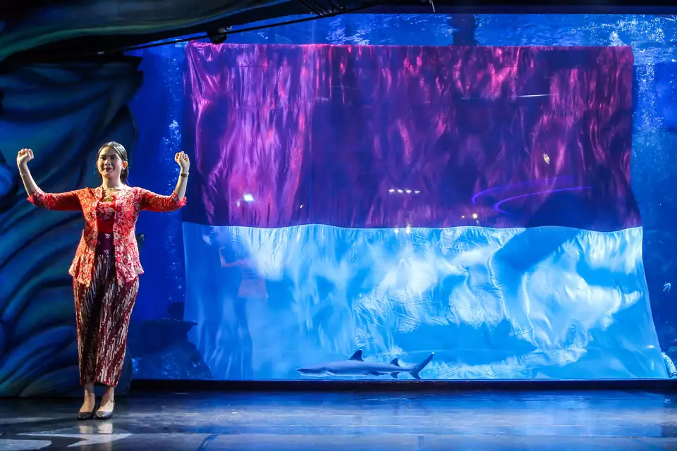 A woman conducts a choir performing the national anthem Indonesia Raya at the Jakarta Aquarium, Sunday, Aug. 17, 2025. (Antara Photo/Naufal Khoirulloh)