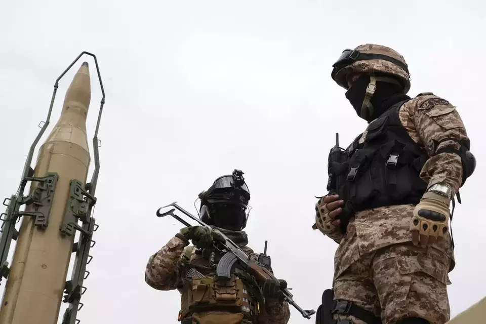 FILE--Iran's Revolutionary Guard members stand in front of a Shahab-3 missile which is displayed during the annual pro-Palestinians Al-Quds, or Jerusalem, Day rally in Tehran, Iran, April 29, 2022. (AP Photo/Vahid Salemi, File)