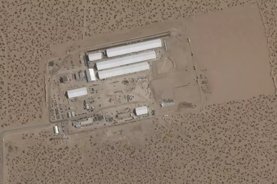 This Aug. 7, 2025, satellite image shows construction of large white tents for a new immigrant detention center at Fort Bliss, a US Army base outside El Paso, Texas. When completed, the $1.2 billion facility is expected to hold up to 5,000 migrants awaiting deportation and will be the largest such facility in the United States. (Planet Labs via AP)