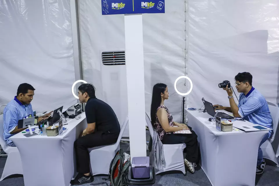 FILE - Immigration officials interview passport applicants at a makeshift service point in Senayan, Jakarta, Sunday, Nov. 16, 2025. The passport service is held as part of the Immigration and Corrections Ministry's first anniversary celebration. (Antara Photo/Asprilla Dwi Adha)