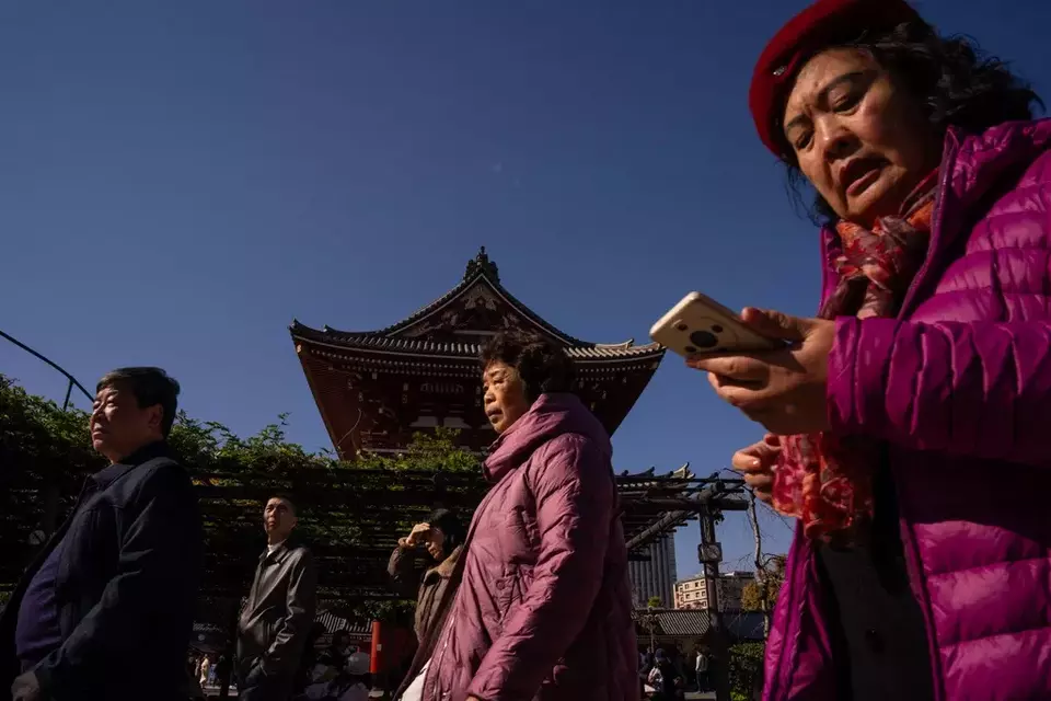 Mainland Chinese tourists visit Sensoji temple in the Asakusa district of Tokyo, Thursday, Nov. 20, 2025. (AP Photo/Louise Delmotte)
