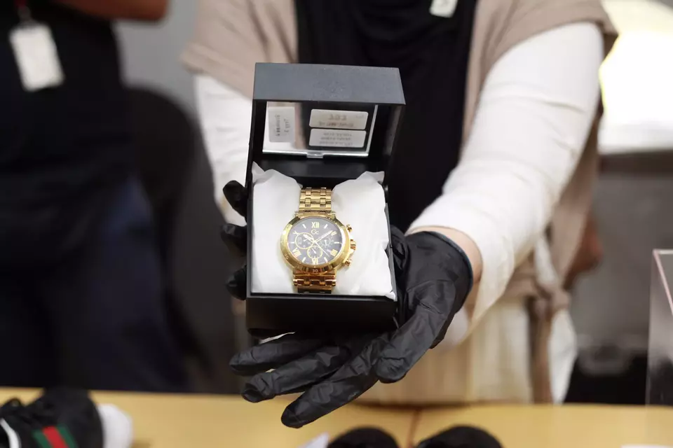 FILE - A Corruption Eradication Commission (KPK) official displays a luxury watch from the evidence storage set for auction in Jakarta, Wednesday, Nov. 26, 2025. (Antara Photo/Reno Esnir)