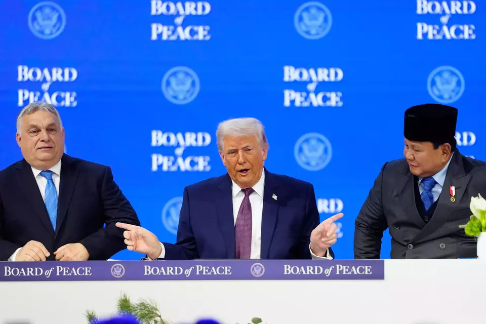 President Donald Trump sits between President of Indonesia Prabowo Subianto, right, and Prime Minister of Hungary Viktor Orban, left, during a signing ceremony on his Board of Peace initiative at the Annual Meeting of the World Economic Forum in Davos, Switzerland, Thursday, Jan. 22, 2026. (AP Photo/Markus Schreiber)