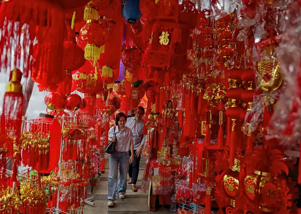 Two visitors look at decorations for Lunar New Year celebrations on sale in Glodok, West Jakarta, on Tuesday, Feb. 2026. (Joanito De Saojoao)
