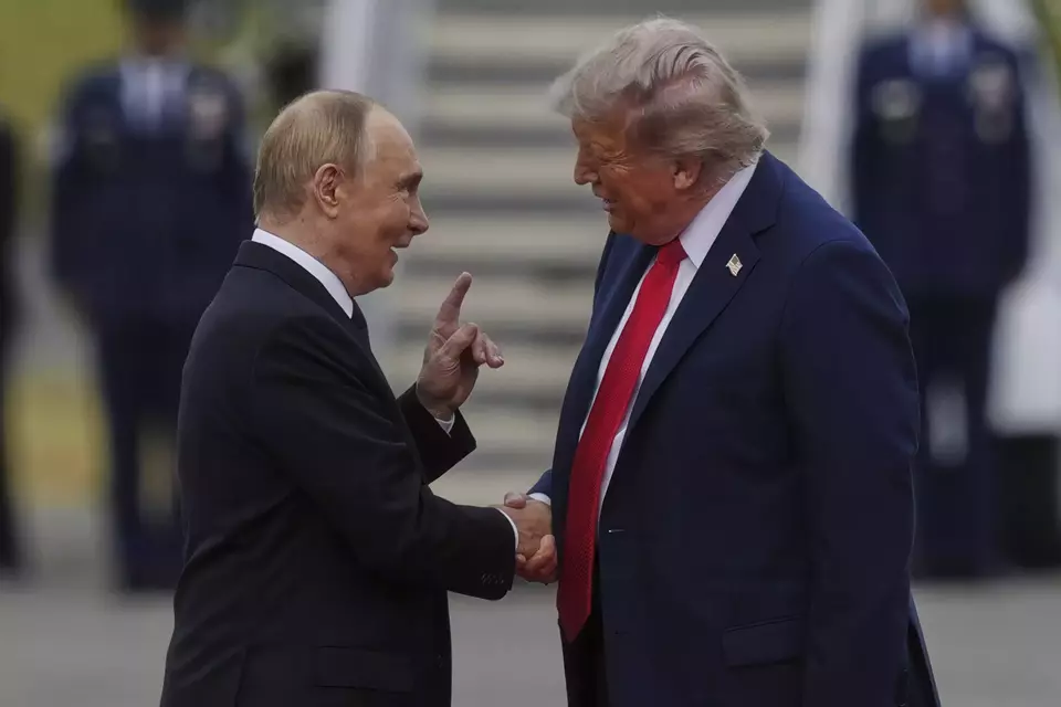 US President Donald Trump greets his Russian counterpart Vladimir Putin at Joint Base Elmendorf-Richardson in Alaska on Aug. 15, 2025. (AP Photo/Julia Demaree Nikhinson)