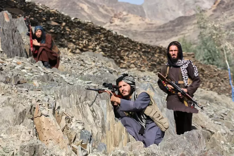 Afghan Taliban soldiers look toward the Pakistani side, with one peering through the sight of his rifle, on the Afghan side of the Torkham border crossing with Pakistan in Torkham, Afghanistan, Friday, Feb. 27, 2026. (AP Photo/Wahidullah Kakar)
