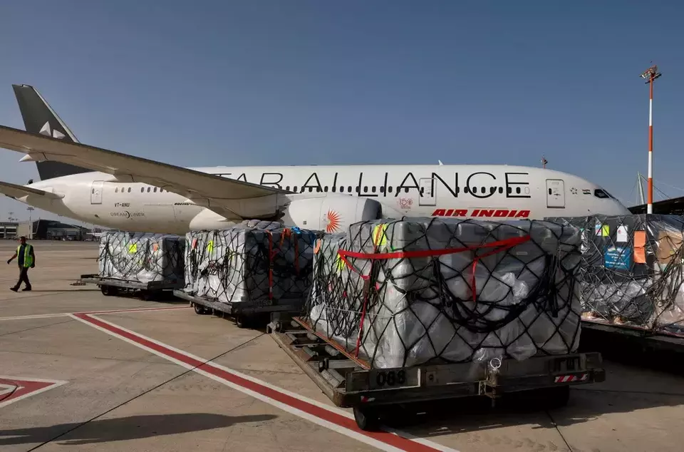 FILE -Workers load medical aid onto an Air India plane to be flown to India, at Ben Gurion Airport near Tel Aviv, Israel, May 4, 2021. (Menahem Kahana/Pool Photo via AP, File)

