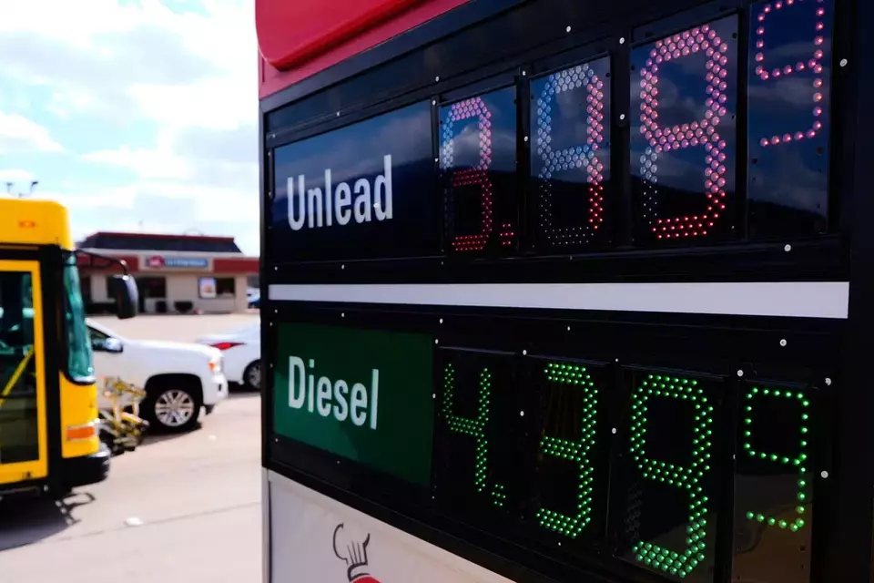 A sign reflects the current gas prices at a convenience store and filling station as motorists pass through an intersection in Garland, Texas, Monday, March 9, 2026. (AP Photo/Tony Gutierrez)