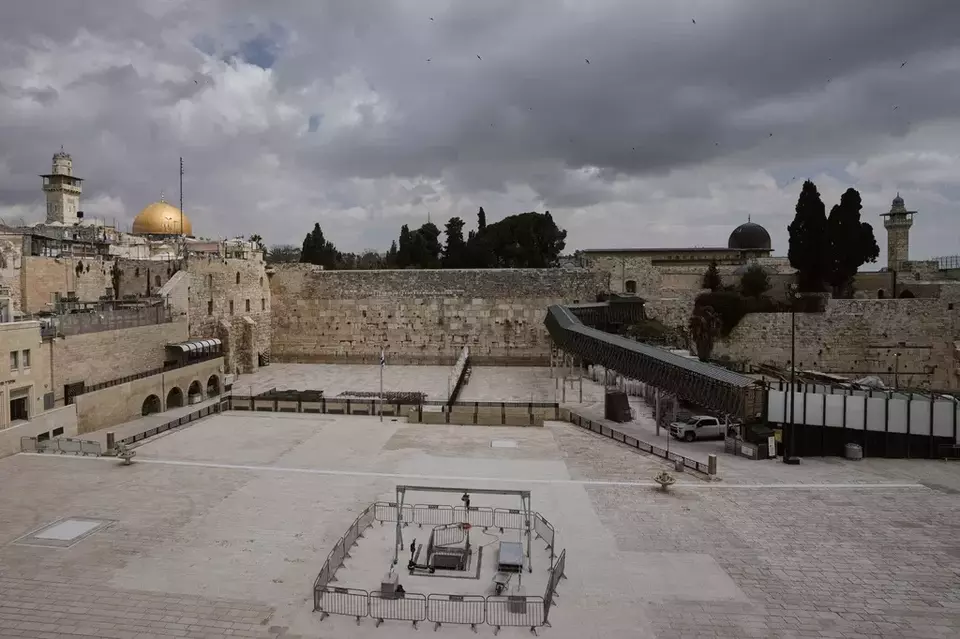 The Western Wall plaza in Jerusalem's Old City stands empty as the area remains closed to visitors amid the war with Iran, Wednesday, March 25, 2026. (AP Photo/Mahmoud Illean)