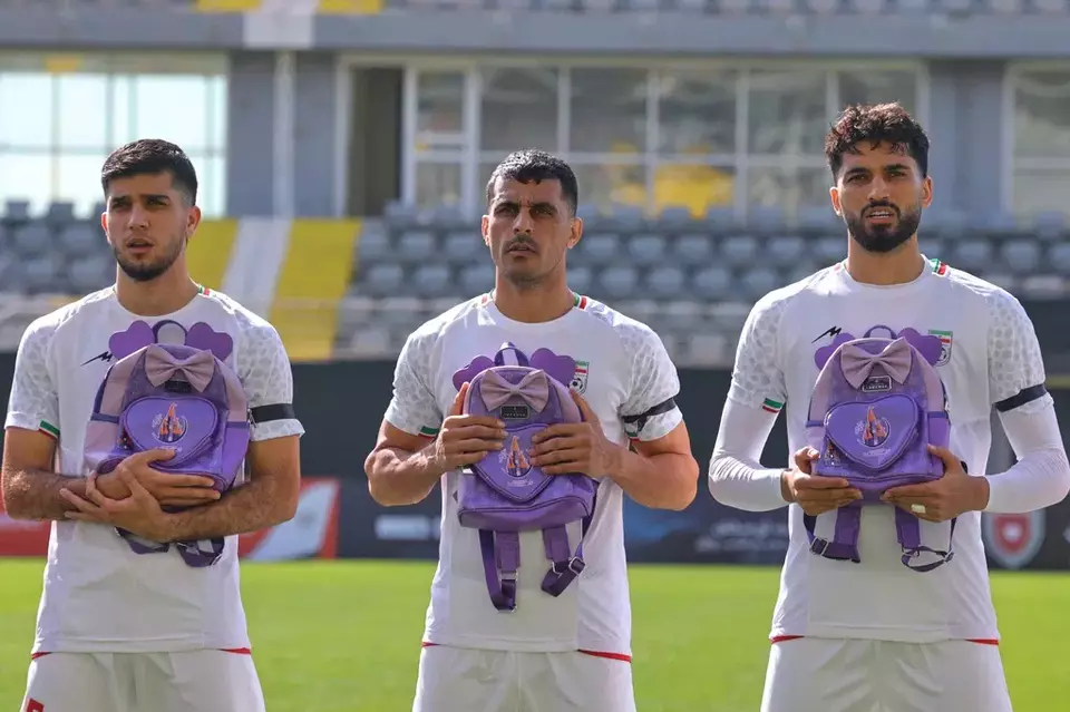 Iran's players sing national anthem holding school bags symbolizing children allegedly killed in a US strike on a school in Minab before a friendly soccer match between Iran and Nigeria, in Antalya, southern Turkey, Friday, March 27, 2026. (AP Photo/Riza Ozel)

