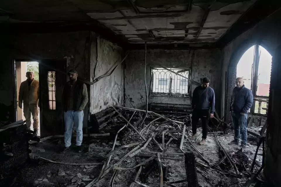 Palestinians inspect a torched house following Israeli settlers' rampage through nearby Nablus-area villages on Sunday night, in West Bank village of Deir al-Hatab, Monday, March 23, 2026. (AP Photo/Majdi Mohammed)

