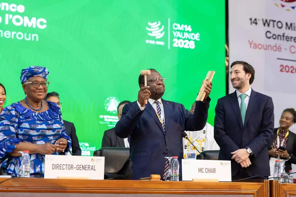 WTO Director-General Ngozi Okonjo-Iweala, left, and Cameroonian Trade Minister Luc Magloire Mbarga Atangana, center, pose for a photo during the World Trade Organization's 14th ministerial conference in Yaounde, Cameroon, on Monday, March 30, 2026. (Photo courtesy of the WTO)