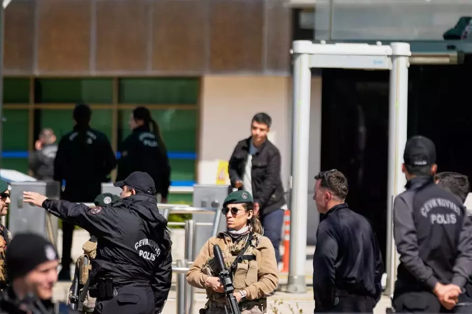 Turkish police and army secure the area after gunmen attacked a building housing the Israeli Consulate in Istanbul, Turkey, Tuesday, April 7, 2026. (AP Photo/Khalil Hamra)